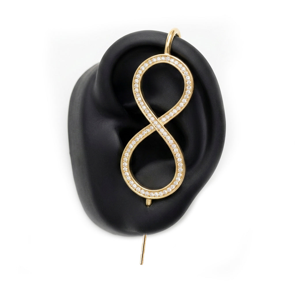Infinity ear cuff in gold on a black ear form