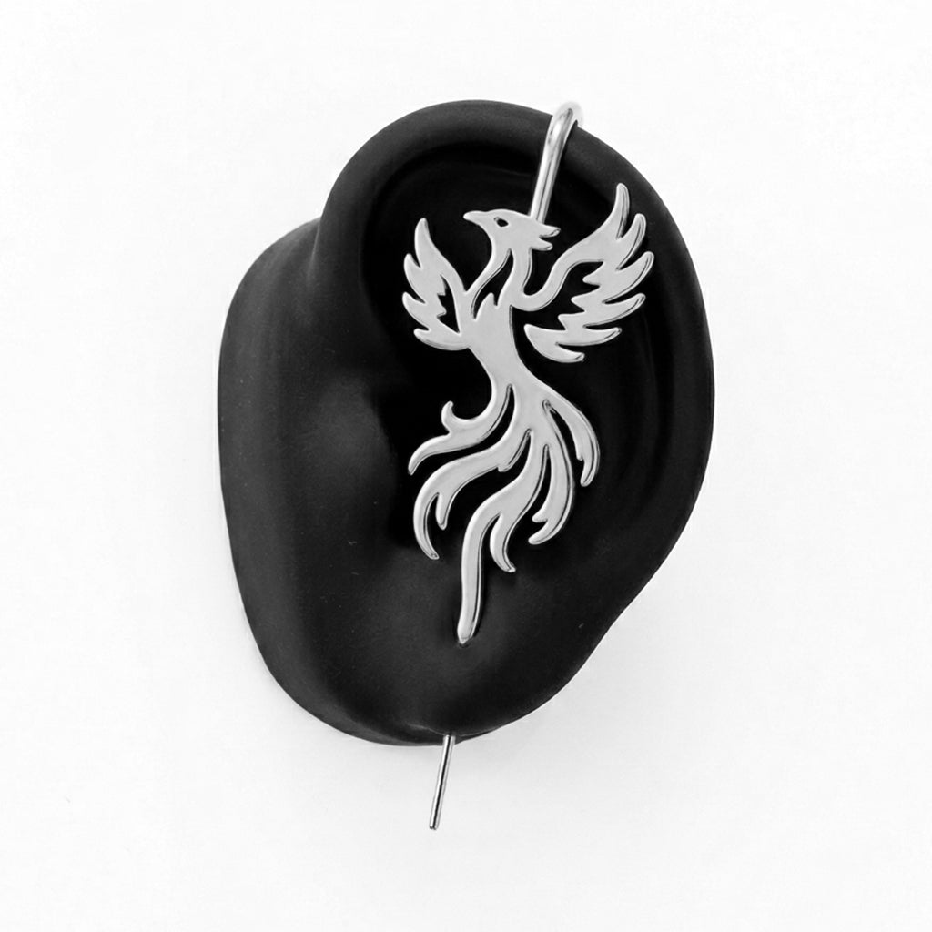 Rising Phoenix ear cuff in silver on a black ear form