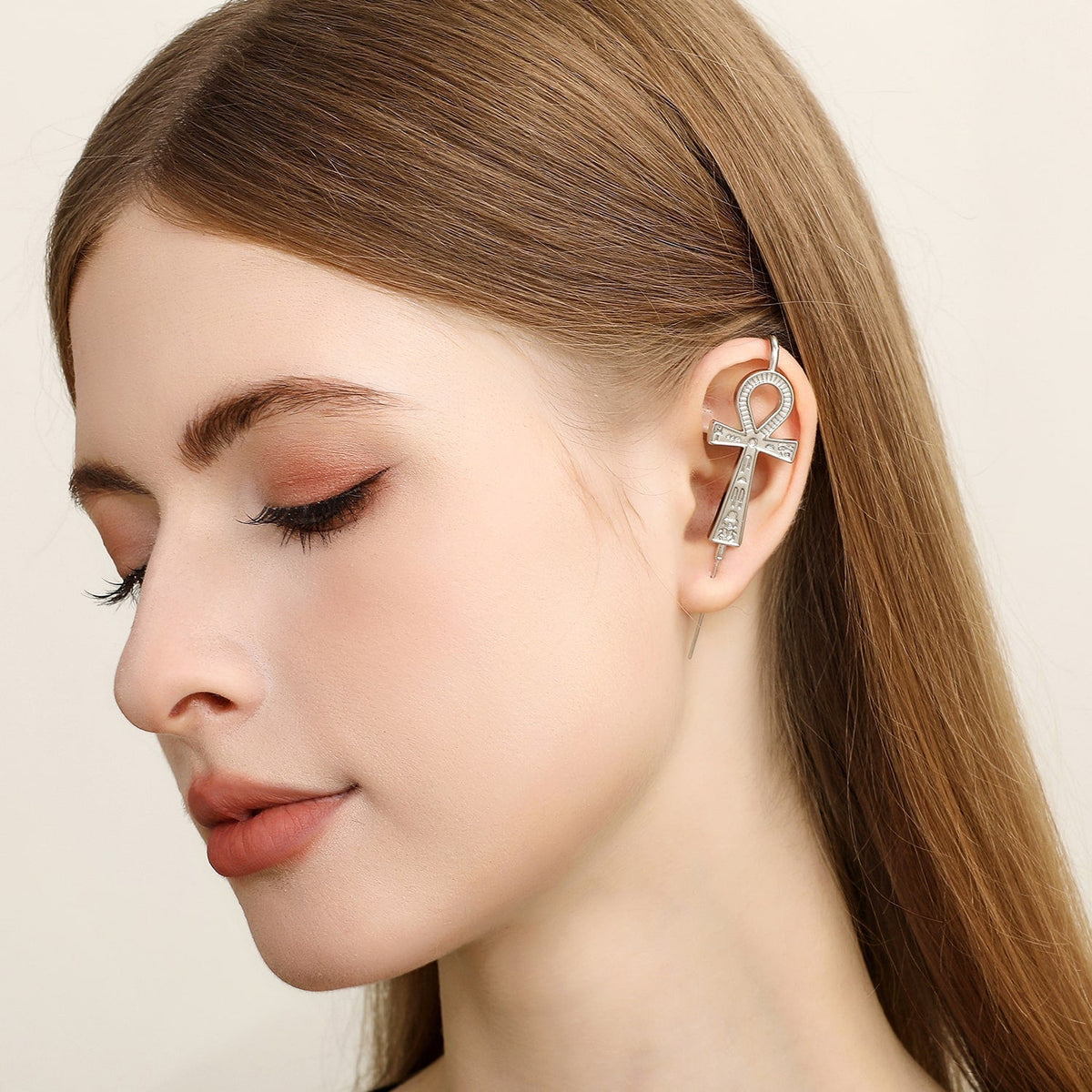 Ankh ear cuff worn on the ear, profile view