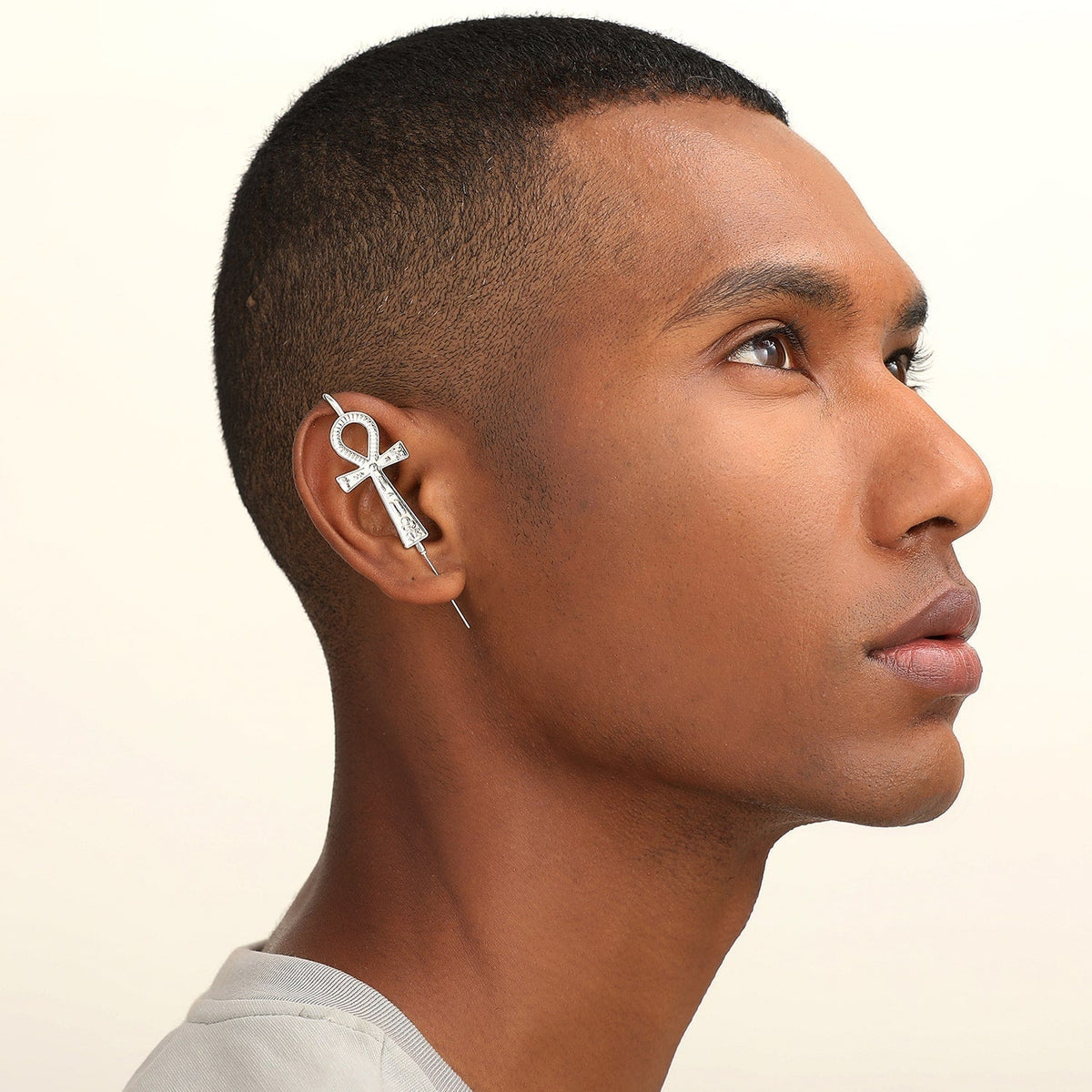 Ankh ear cuff worn on the ear, profile view