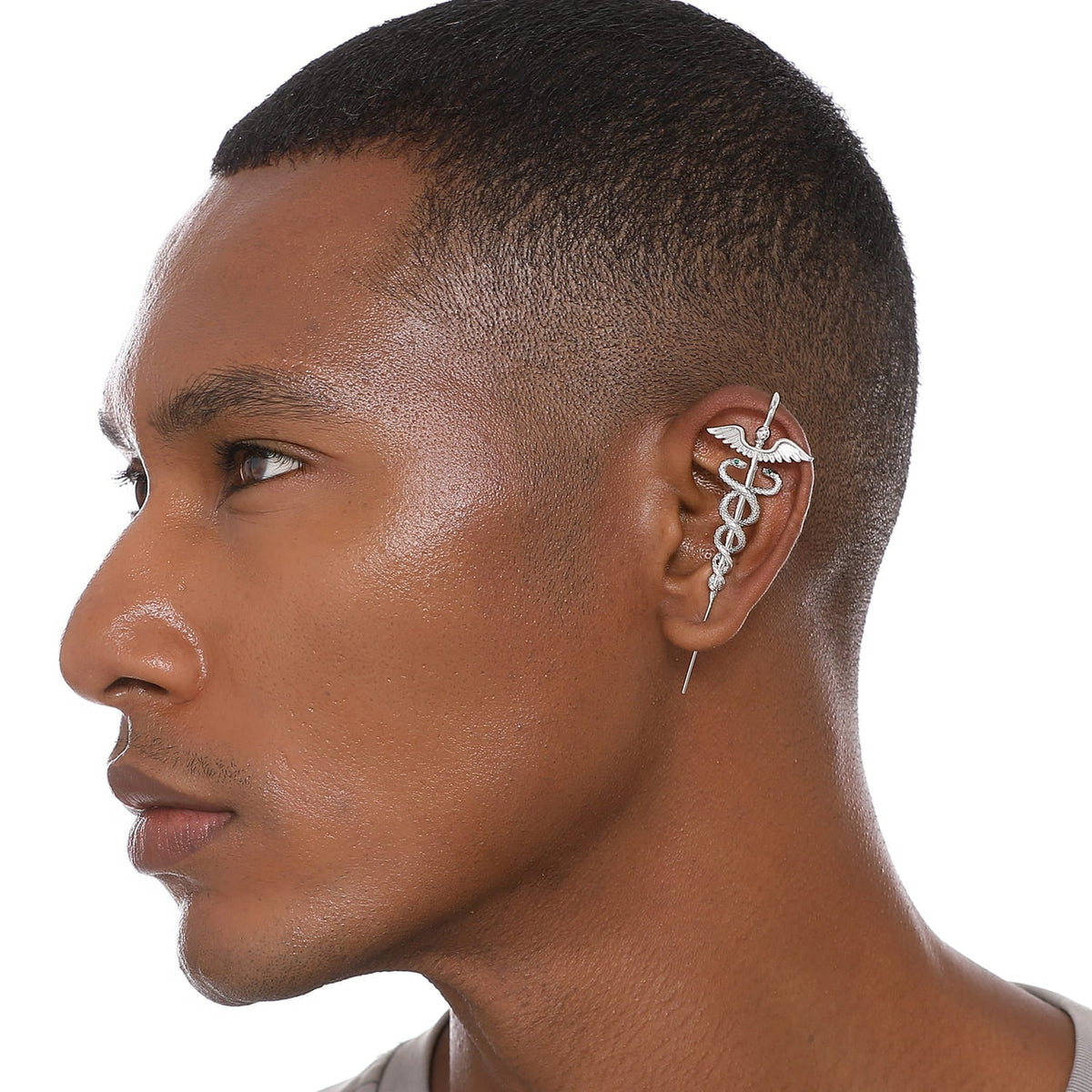 Caduceus ear cuff worn on the ear, profile view