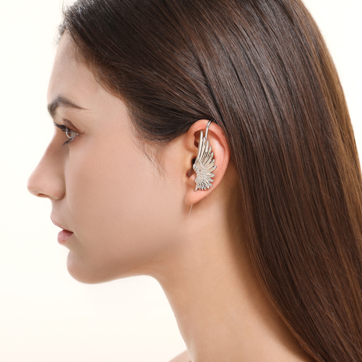 Celestial Wing ear cuff in silver worn on the ear, profile view