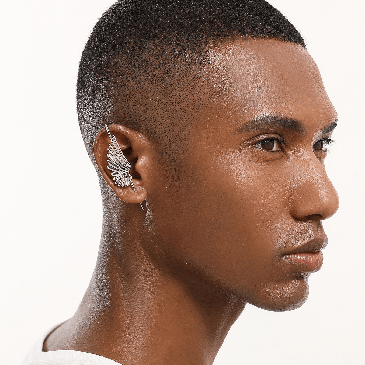Celestial Wing ear cuff in silver worn on the ear, profile view