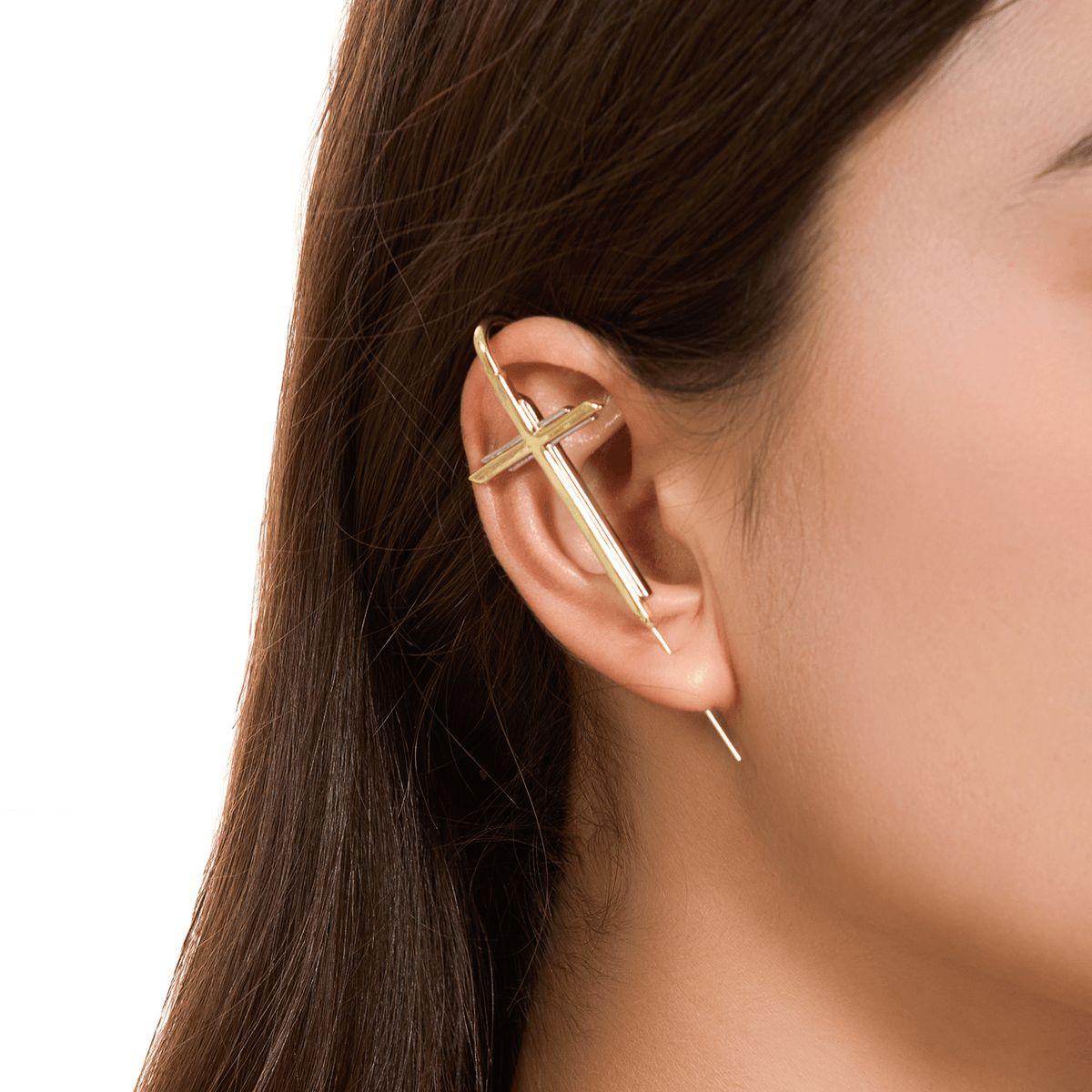 Cross ear cuff in gold worn on the ear, profile view