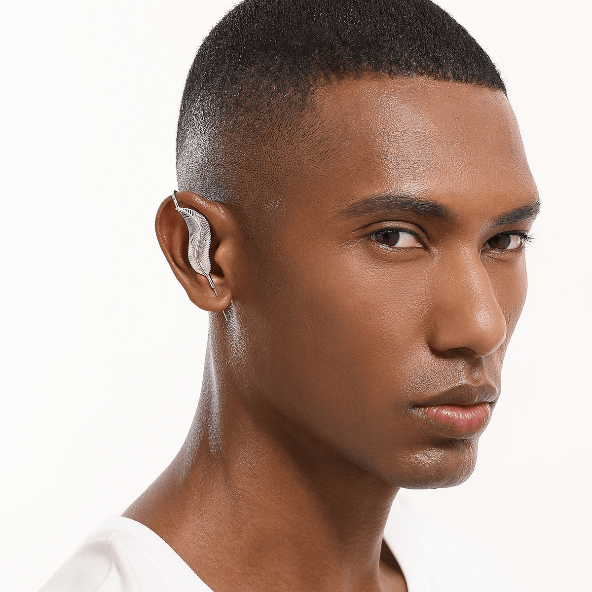 Feathered Grace ear cuff in silver worn on the ear, profile view