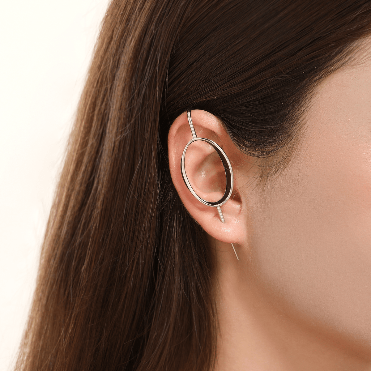 Halo ear cuff in silver worn on the ear, profile view