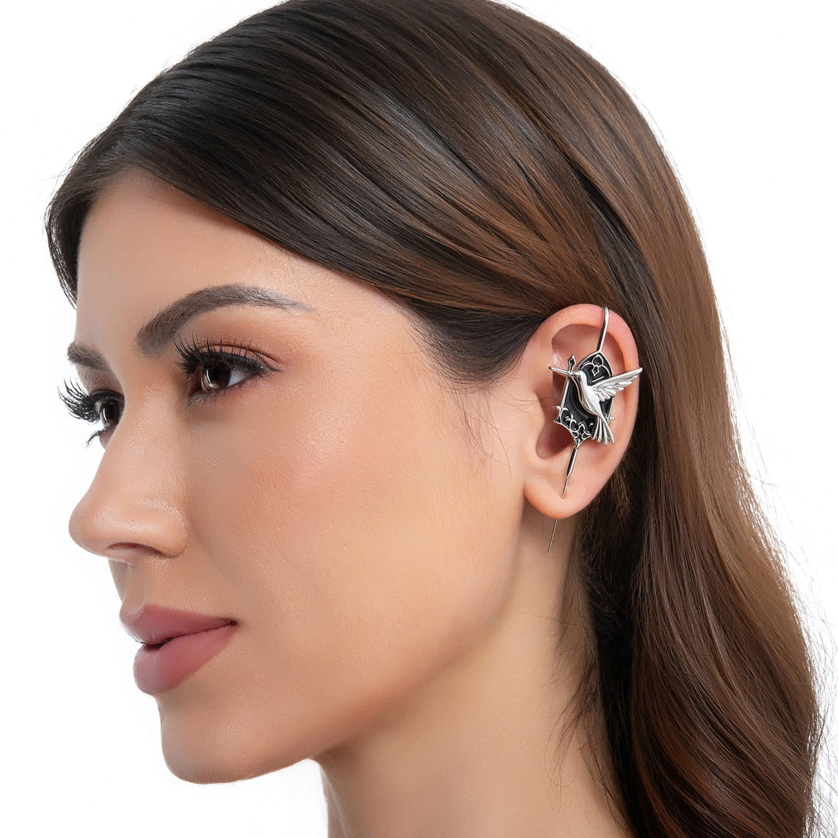 Hummingbird ear cuff in silver on a black ear form