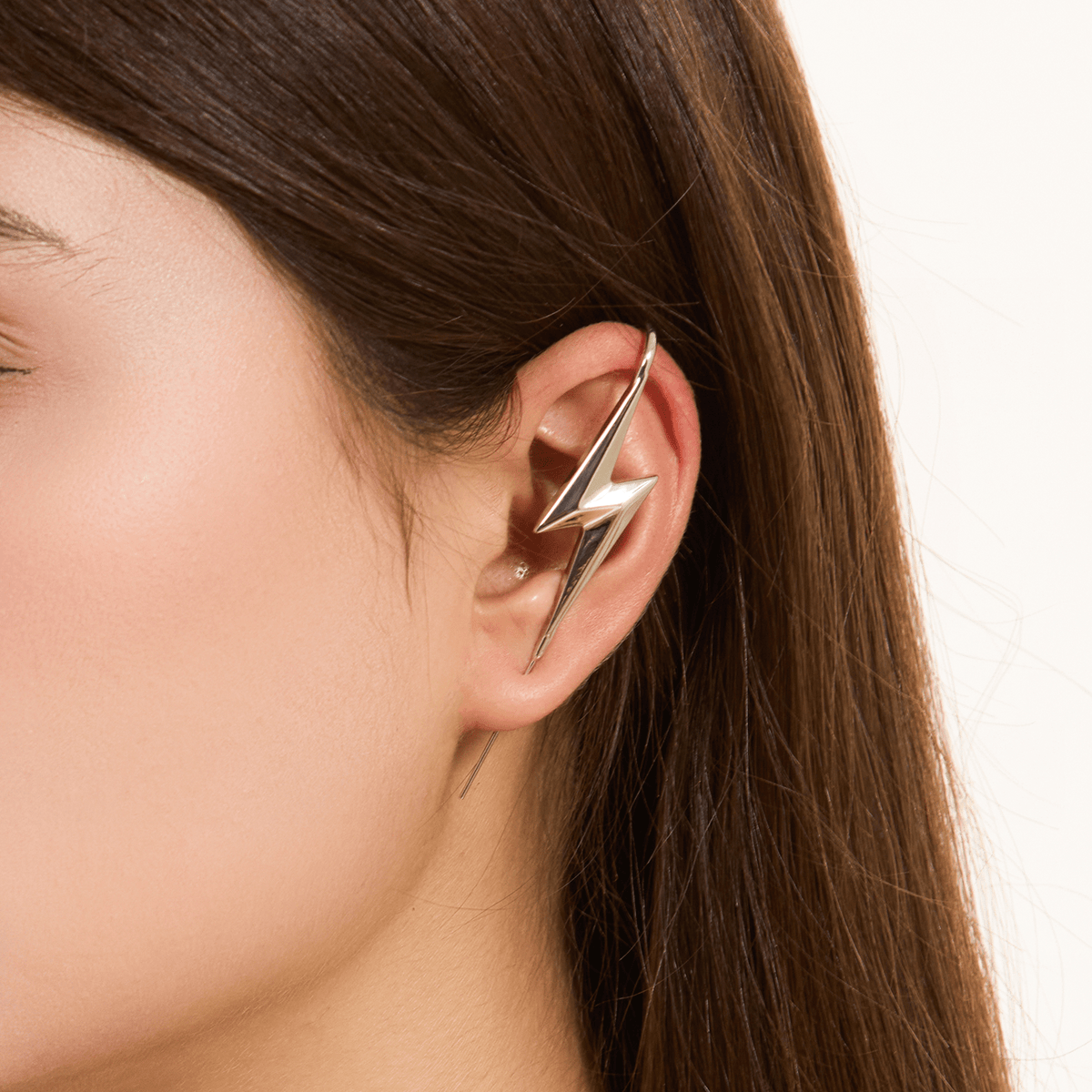 Lightning Bolt ear cuff in silver worn on the ear, profile view