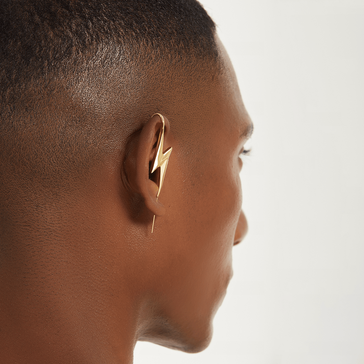 Lightning Bolt ear cuff in gold worn on the ear, profile view