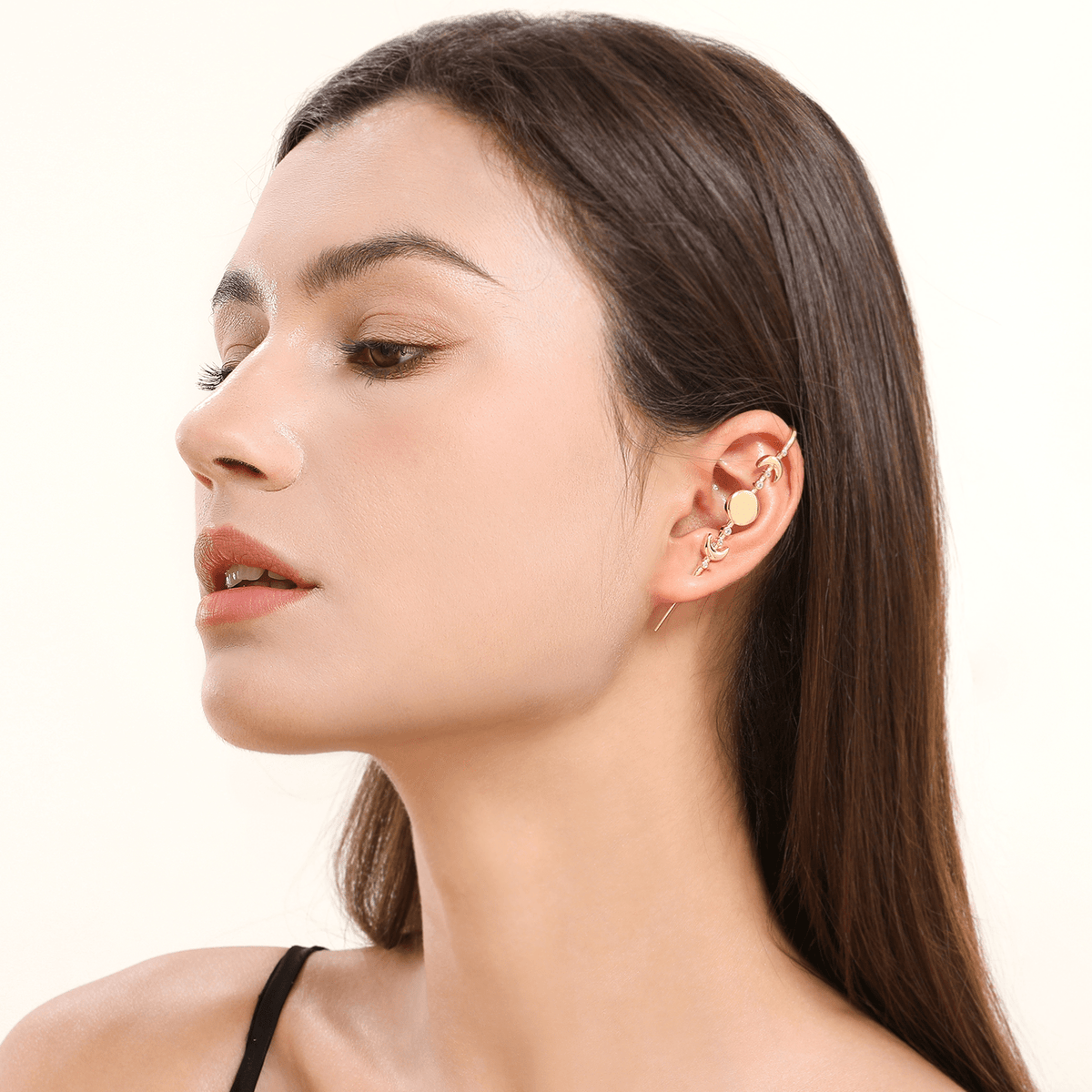 Moon Phases ear cuff in gold worn on the ear, profile view