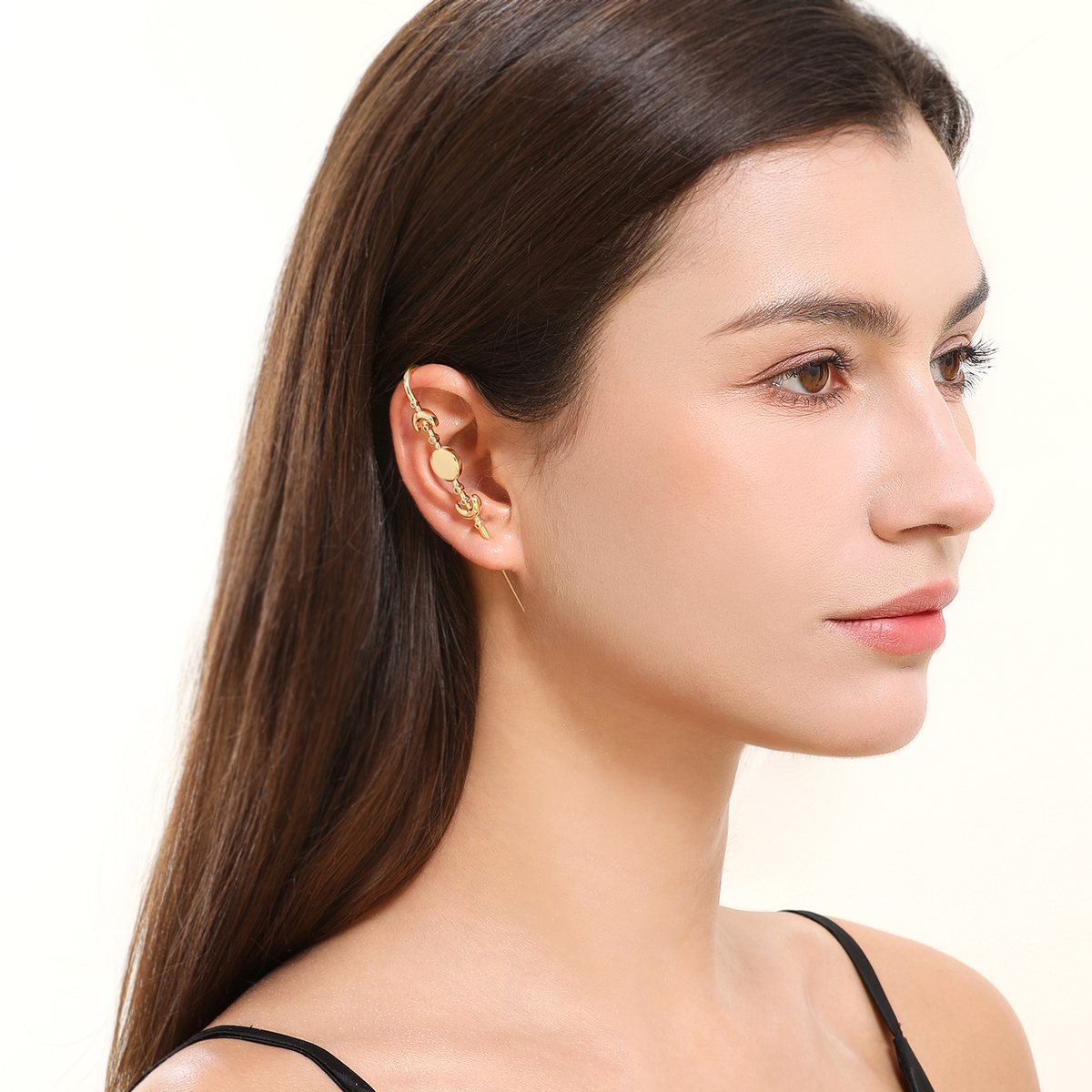 Moon Phases ear cuff in gold worn on the ear, profile view
