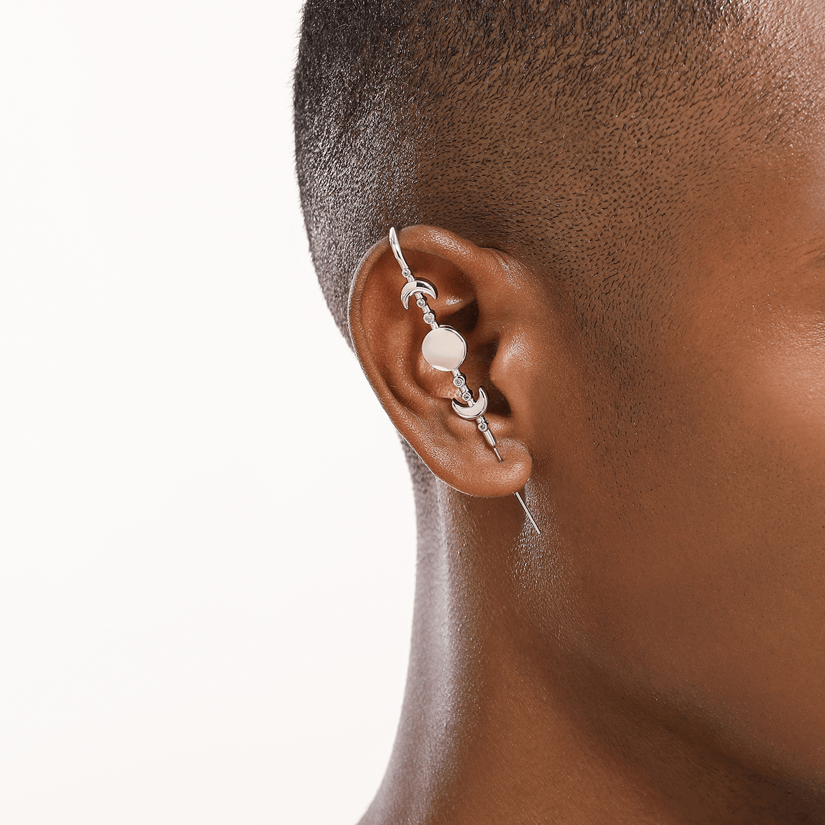 Moon Phases ear cuff in silver worn on the ear, profile view