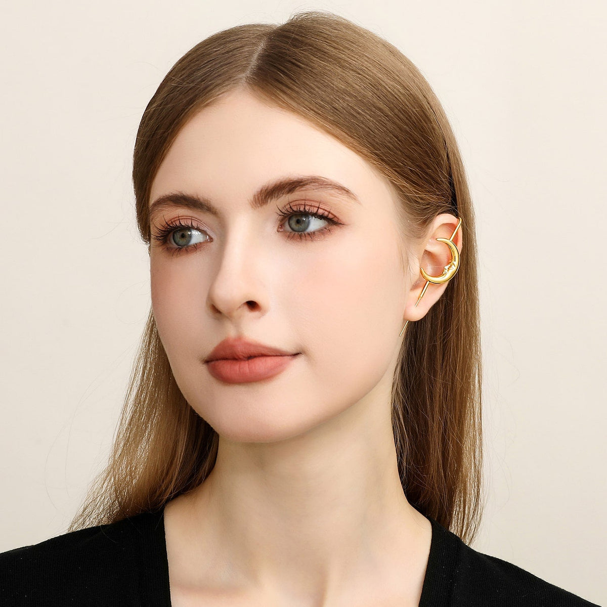 Sun & Moon ear cuff in gold worn on the ear, profile view