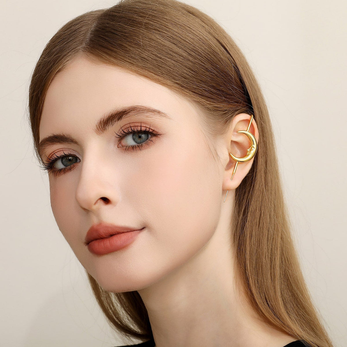 Sun & Moon ear cuff in gold worn on the ear, profile view