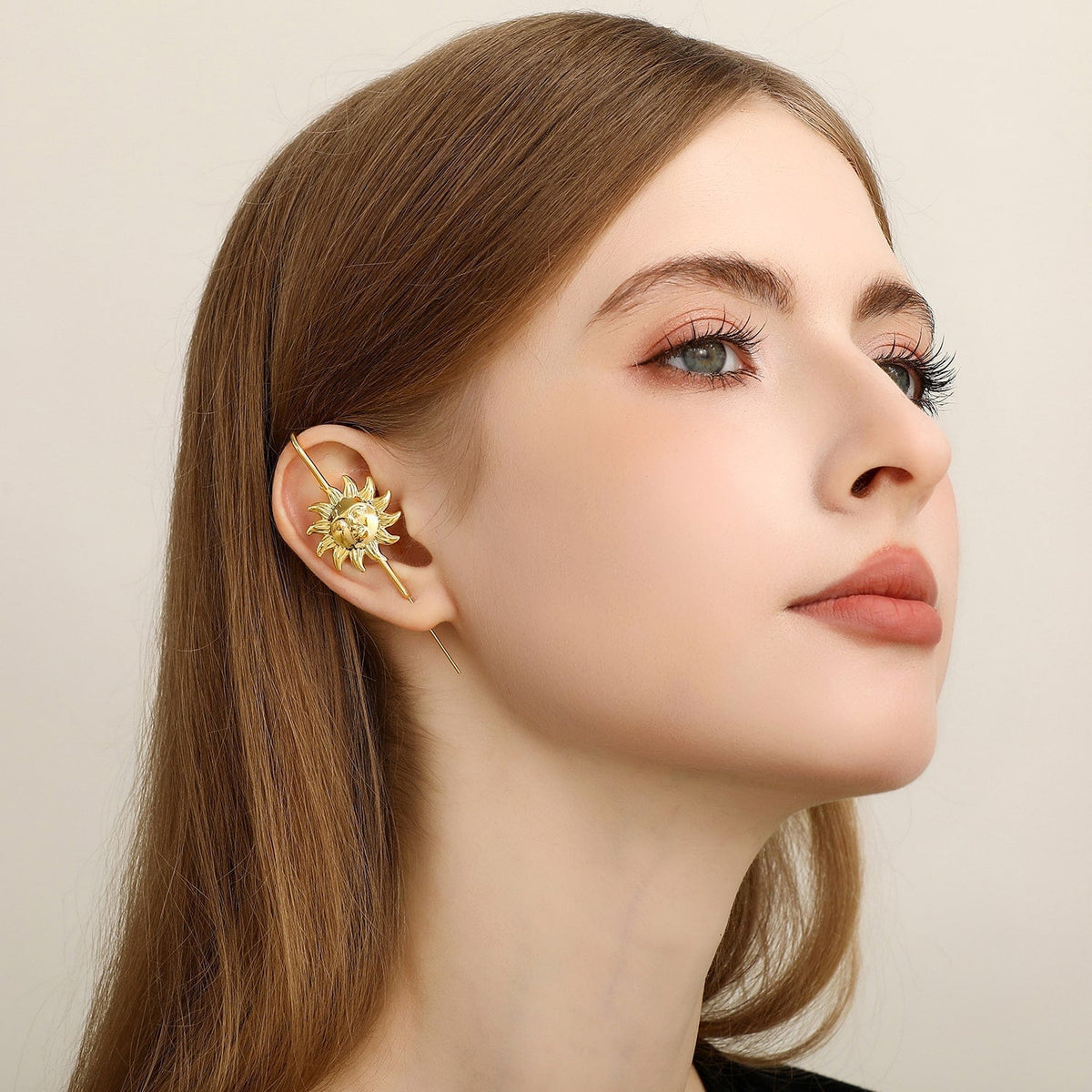 Sun & Moon ear cuff in gold worn on the ear, profile view