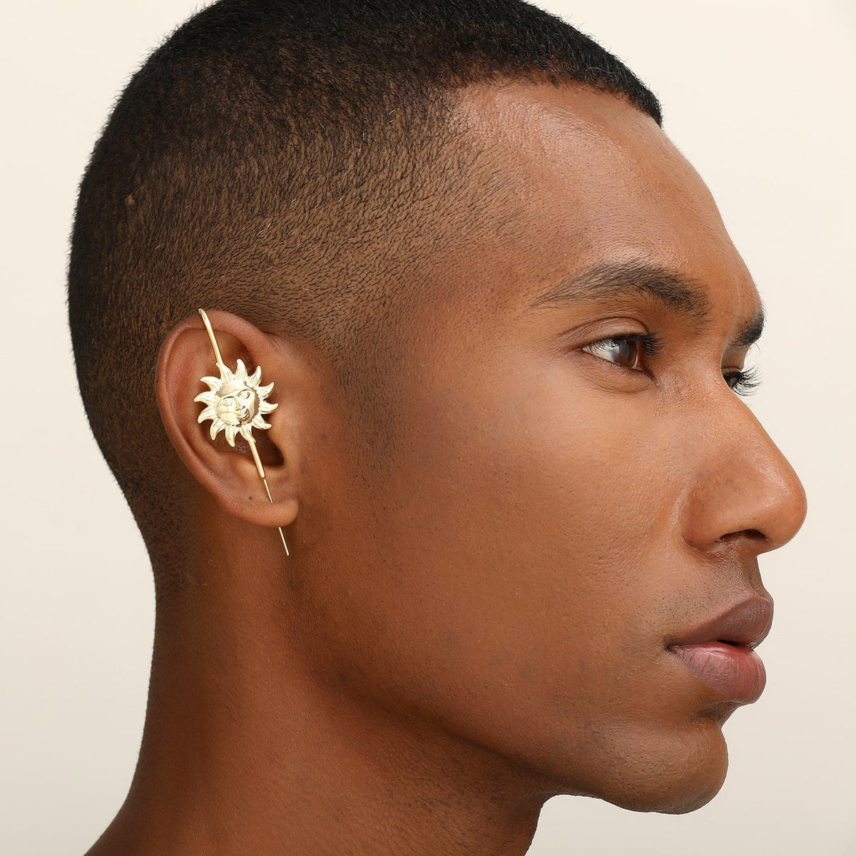 Sun & Moon ear cuff in gold worn on the ear, profile view