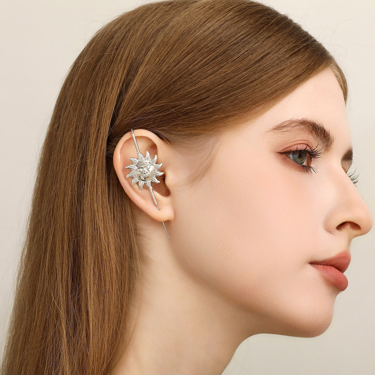 Sun & Moon ear cuff in silver worn on the ear, profile view