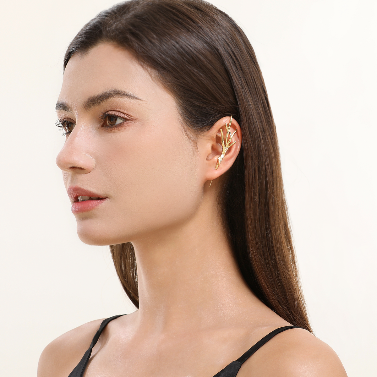Nature's Embrace ear cuff in gold worn on the ear, profile view