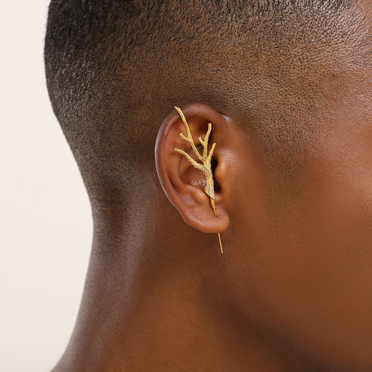 Nature's Embrace ear cuff in gold worn on the ear, profile view