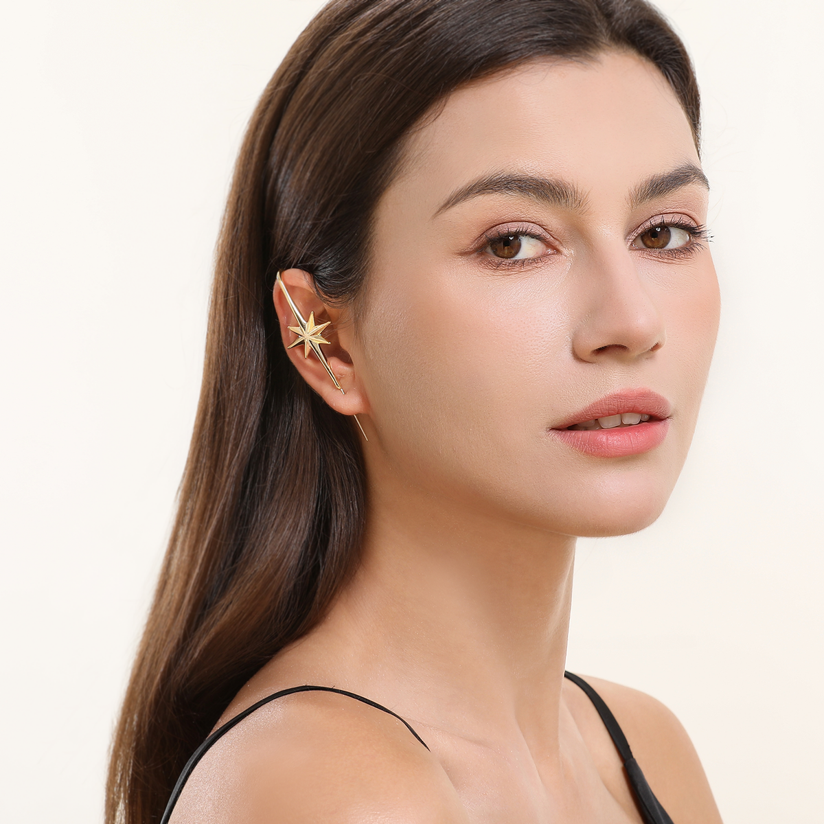 North Star ear cuff in gold worn on the ear, profile view
