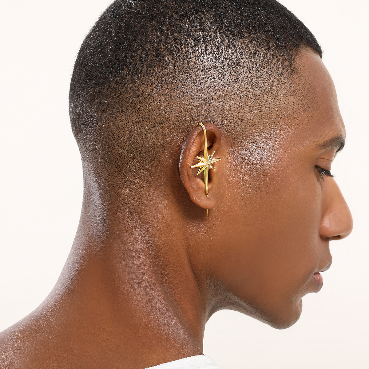 North Star ear cuff in gold worn on the ear, profile view