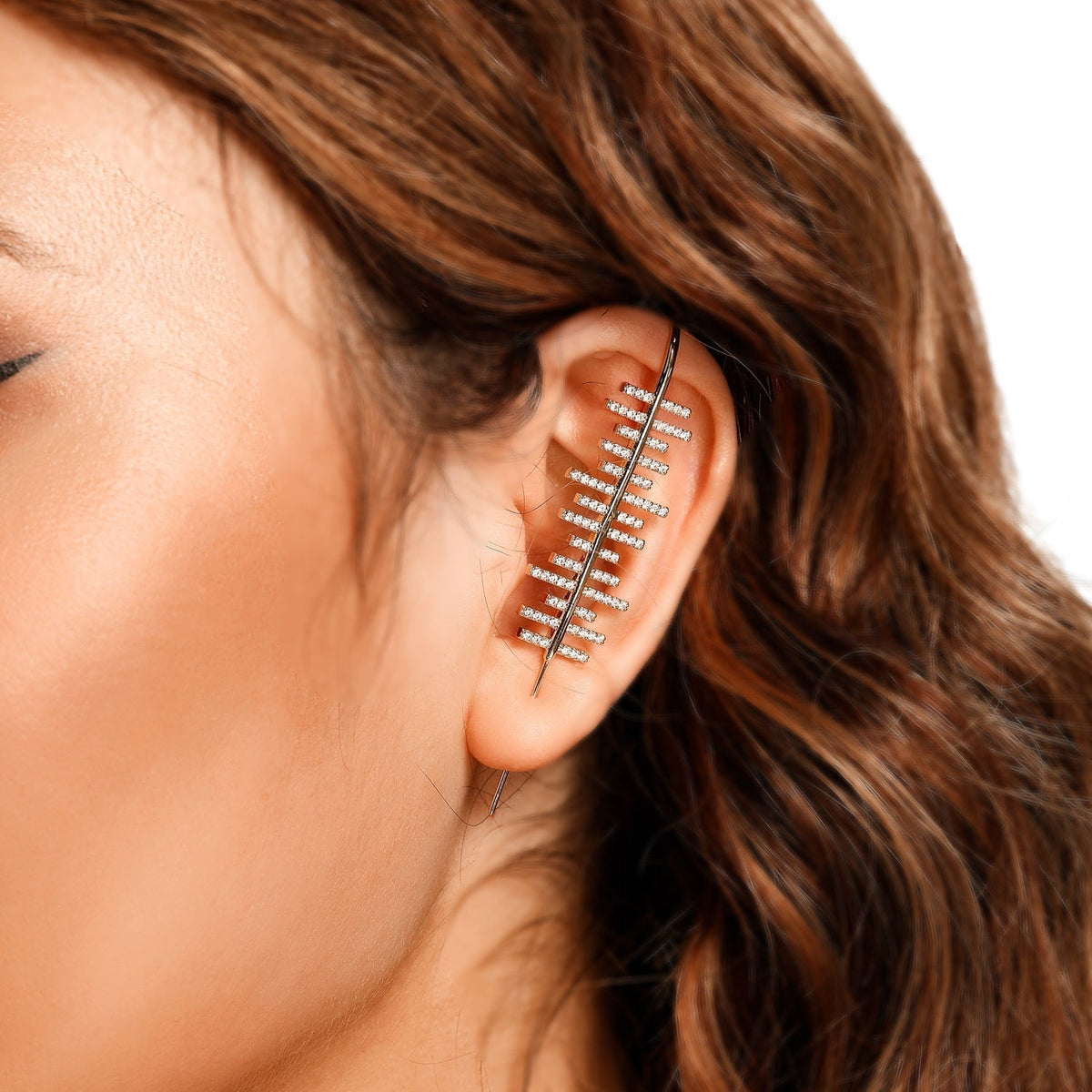 Balance ear cuff in gold on a black ear form