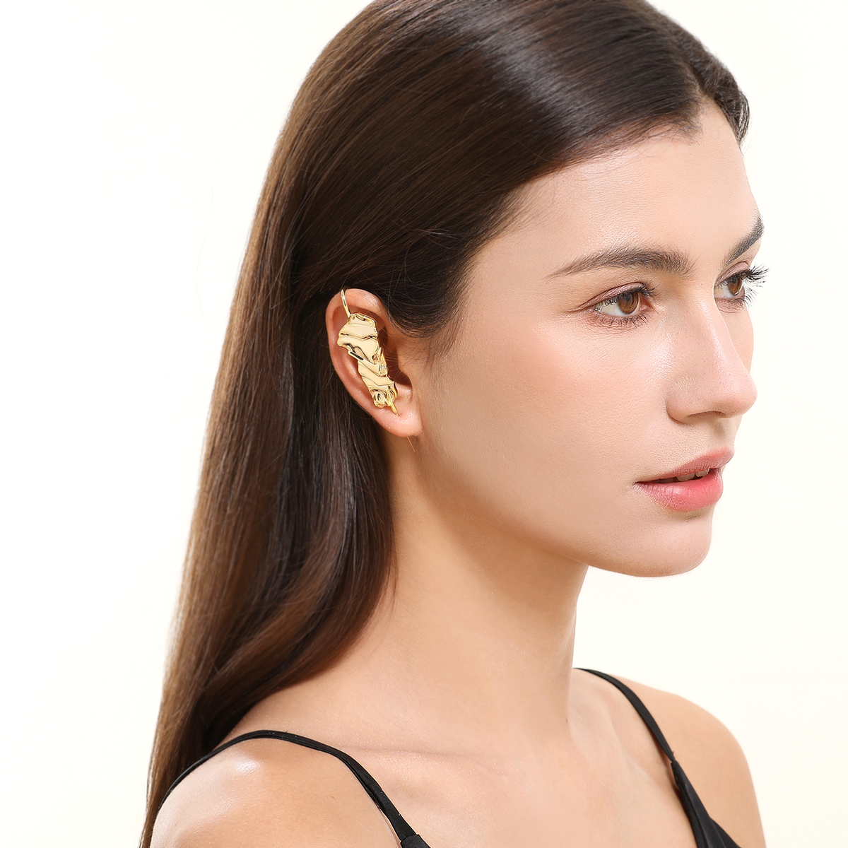Sculpted Cascade ear cuff in gold worn on the ear, profile view