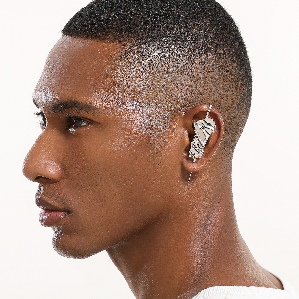 Sculpted Cascade ear cuff in silver worn on the ear, profile view
