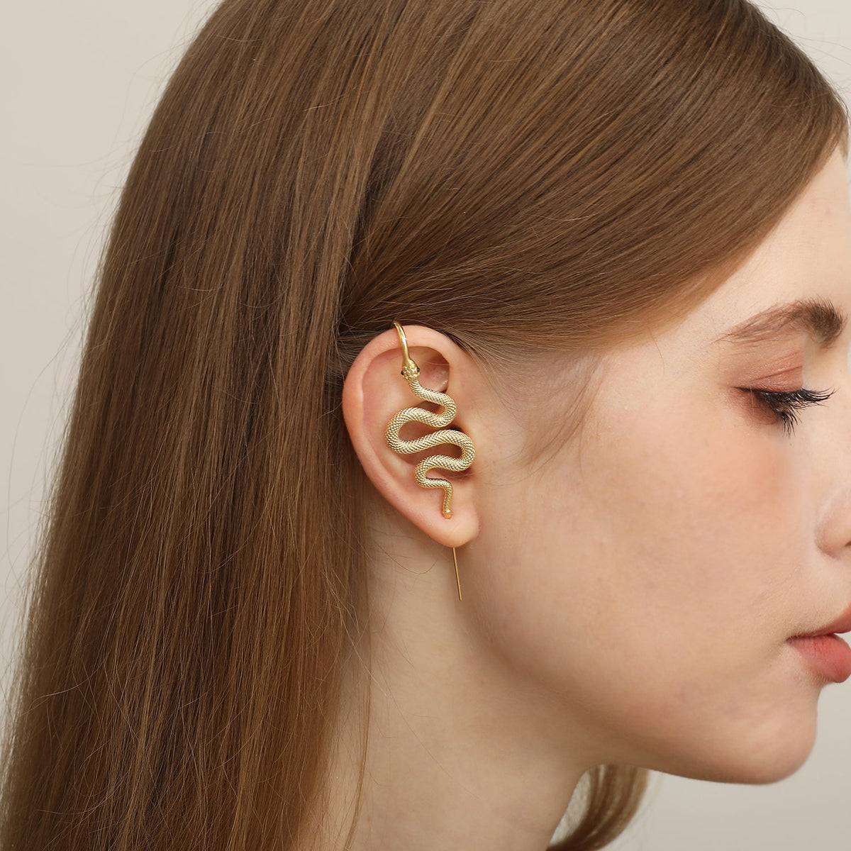 Serpent ear cuff worn on the ear, profile view