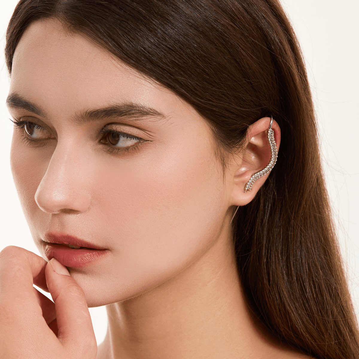 Spine-Chilling ear cuff in silver worn on the ear, profile view