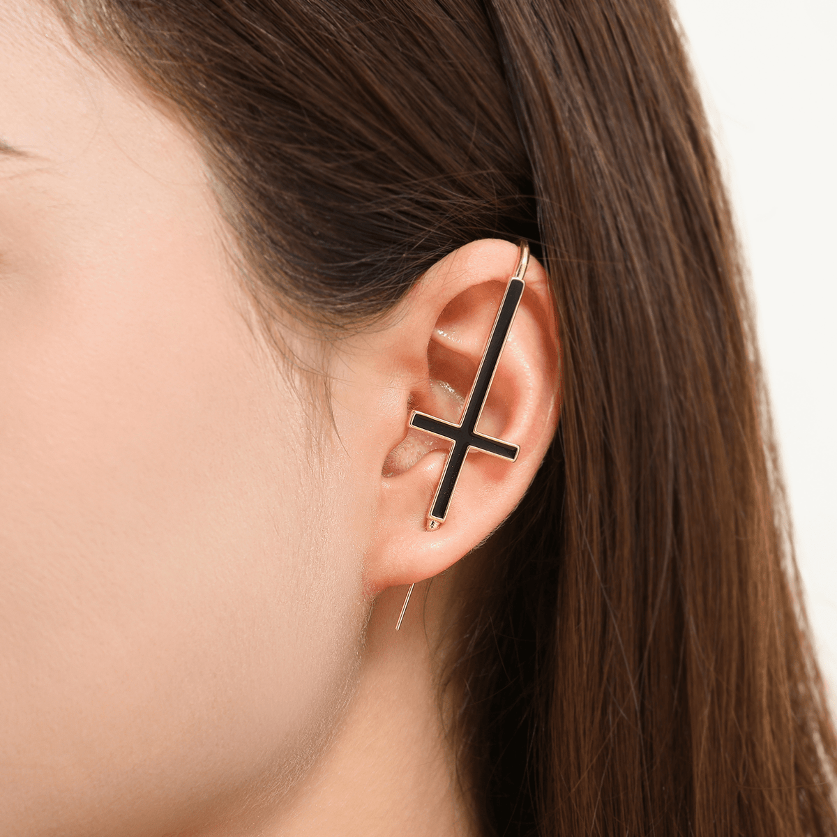 St. Peter Cross ear cuff in gold worn on the ear, profile view