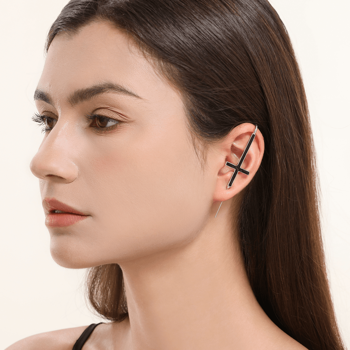 St. Peter Cross ear cuff in silver worn on the ear, profile view