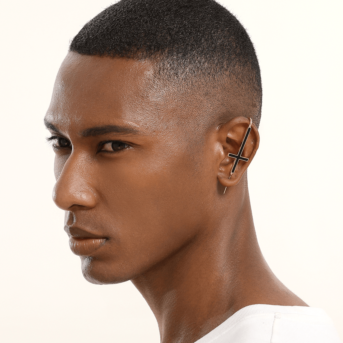 St. Peter Cross ear cuff in gold worn on the ear, profile view