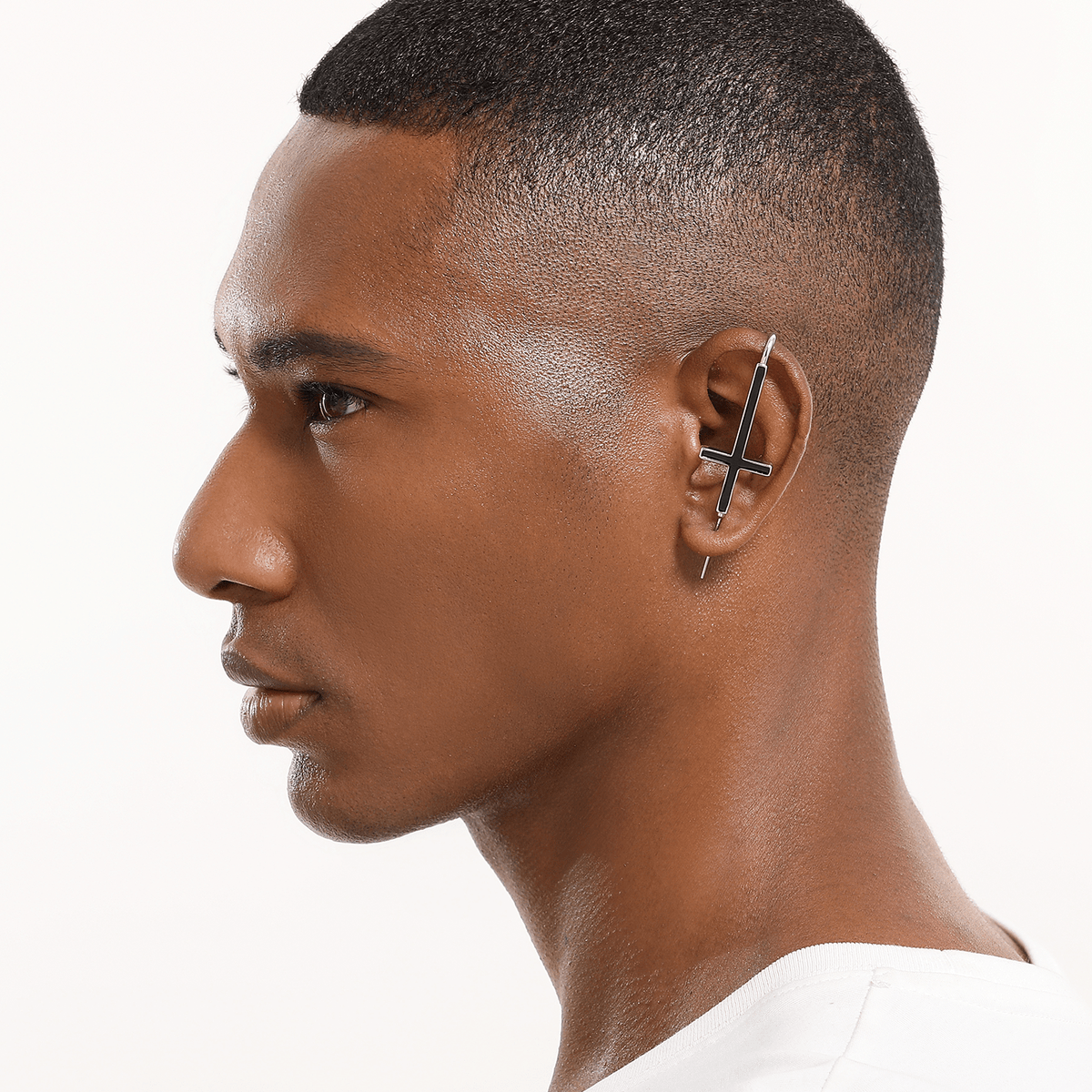 St. Peter Cross ear cuff in silver worn on the ear, profile view