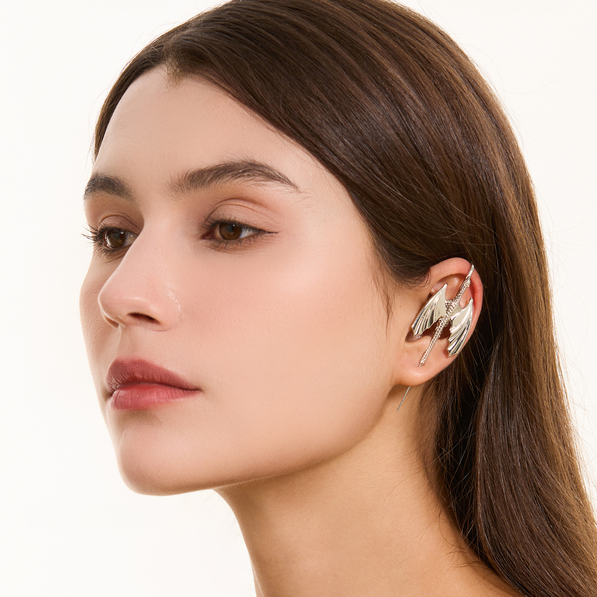 Stormscale ear cuff in silver worn on the ear, profile view