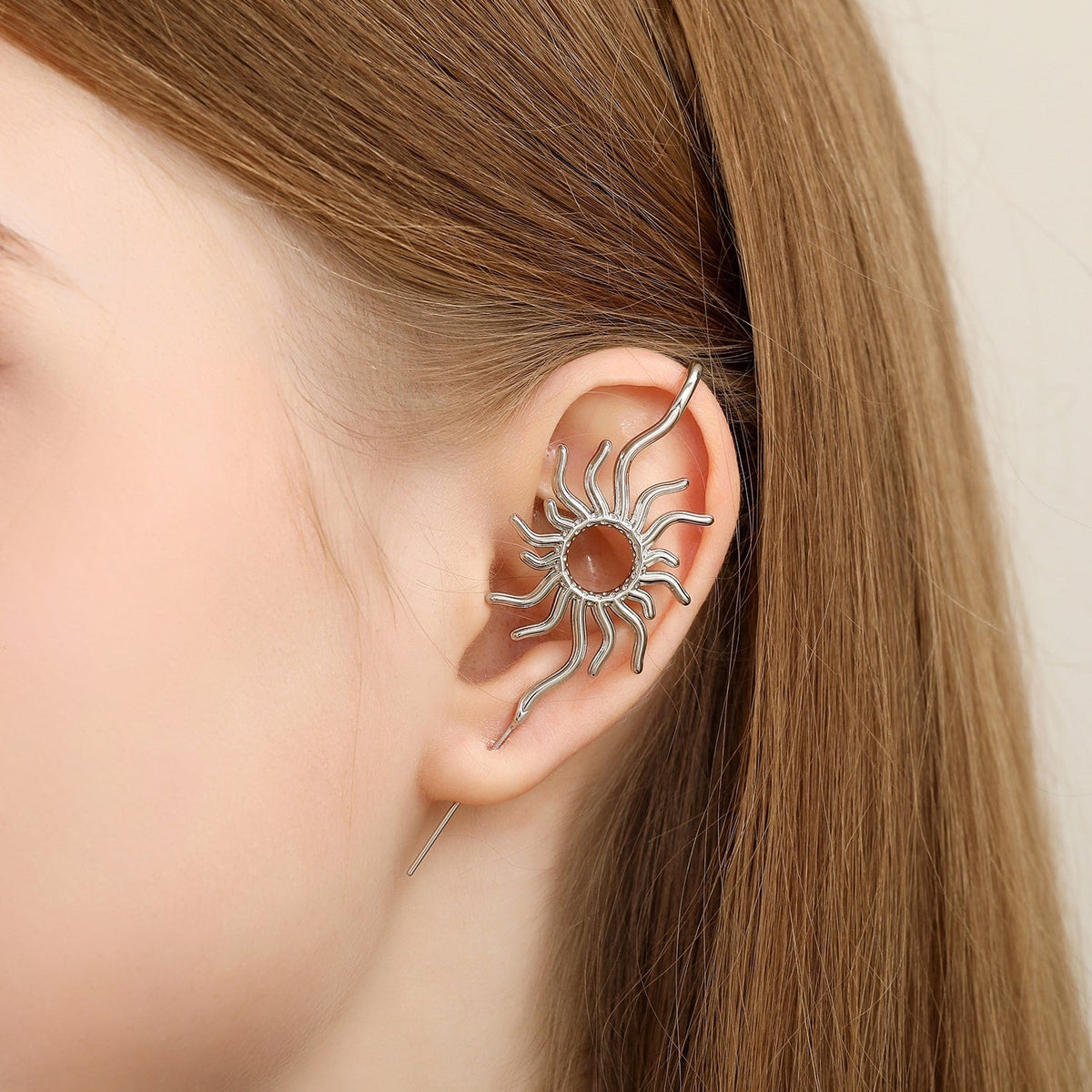 Sunfire ear cuff worn on the ear, profile view