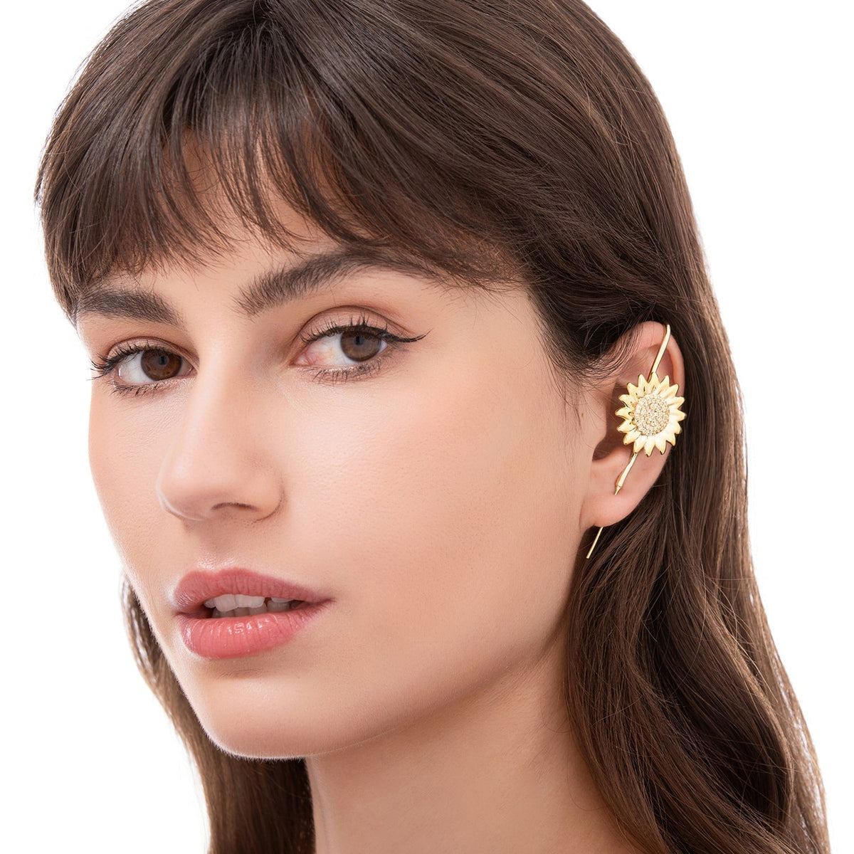 Sunflower ear cuff worn on the ear, profile view
