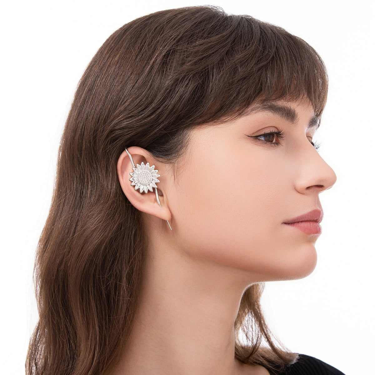 Sunflower ear cuff worn on the ear, profile view