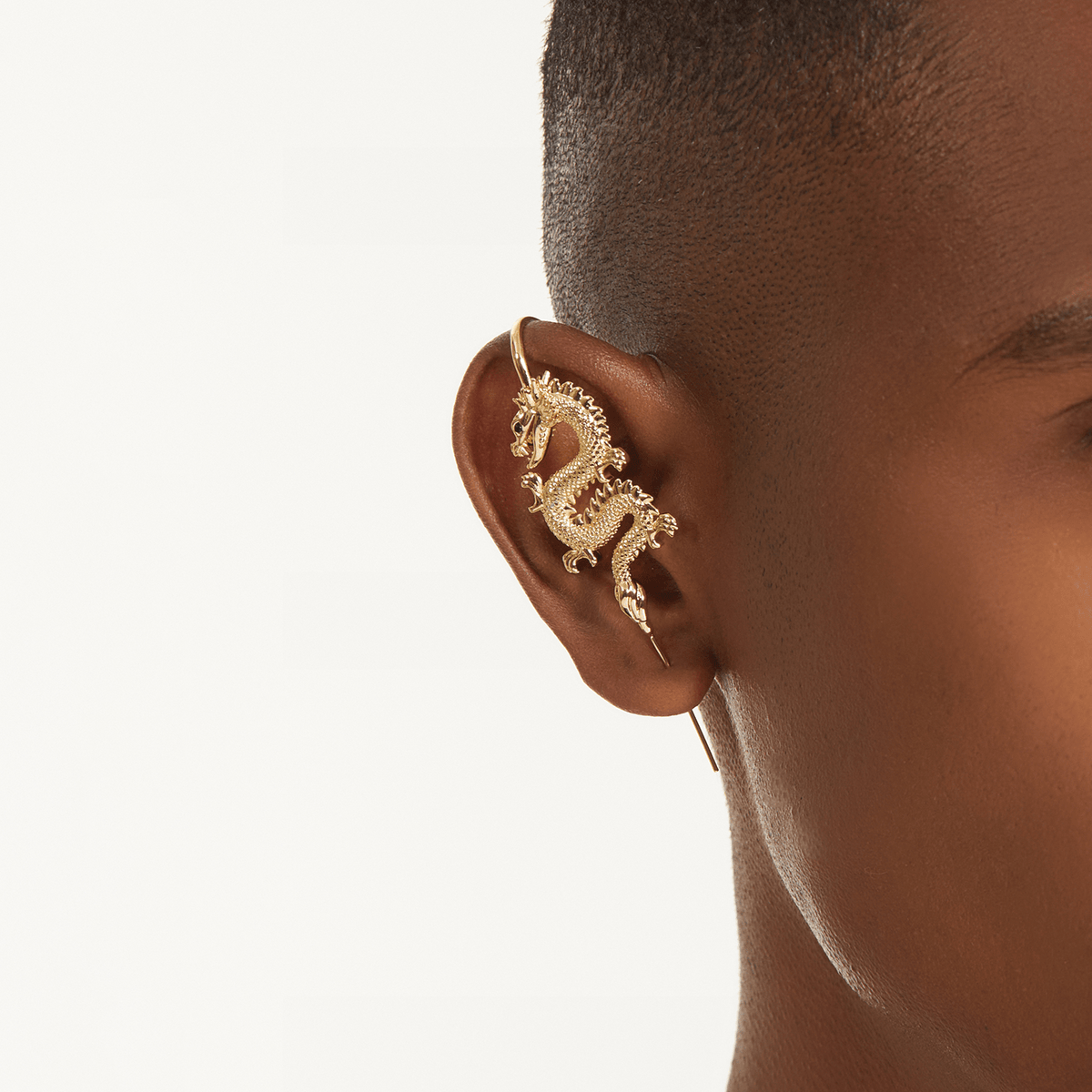 Tianlong 天龙 ear cuff in gold worn on the ear, profile view
