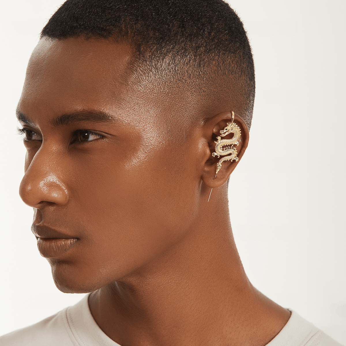 Tianlong 天龙 ear cuff in gold worn on the ear, profile view