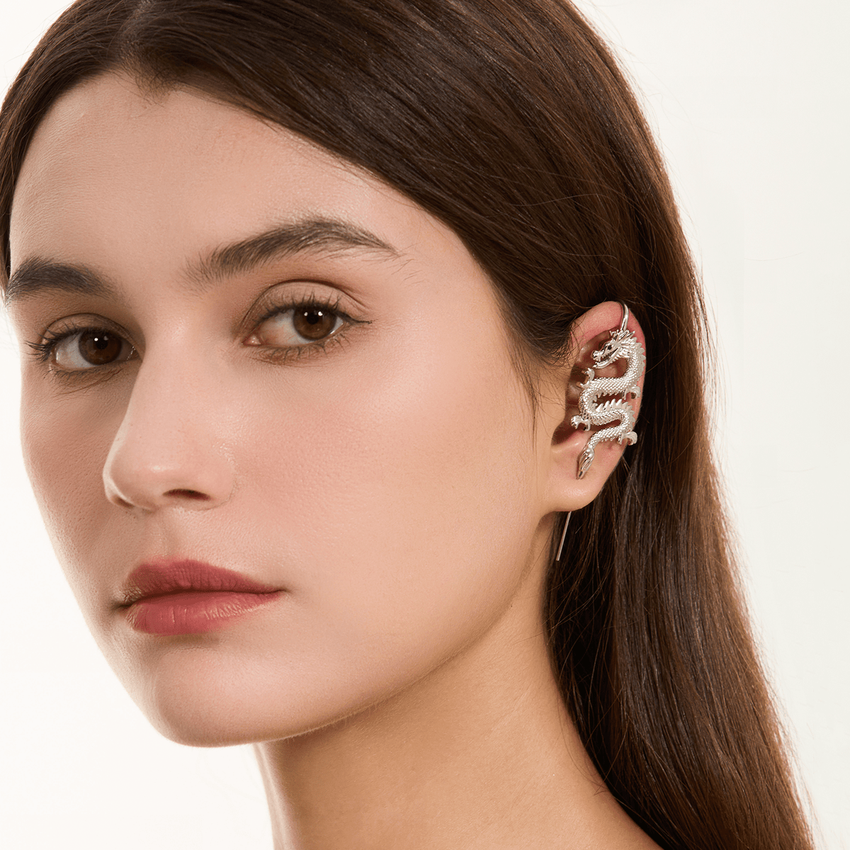 Tianlong 天龙 ear cuff in silver worn on the ear, profile view