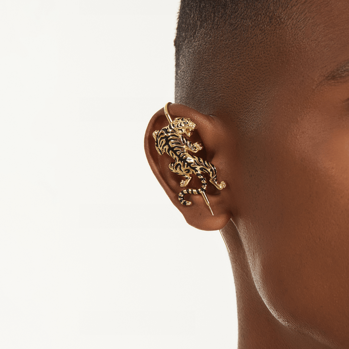 Prowling Tiger ear cuff in gold worn on the ear, profile view