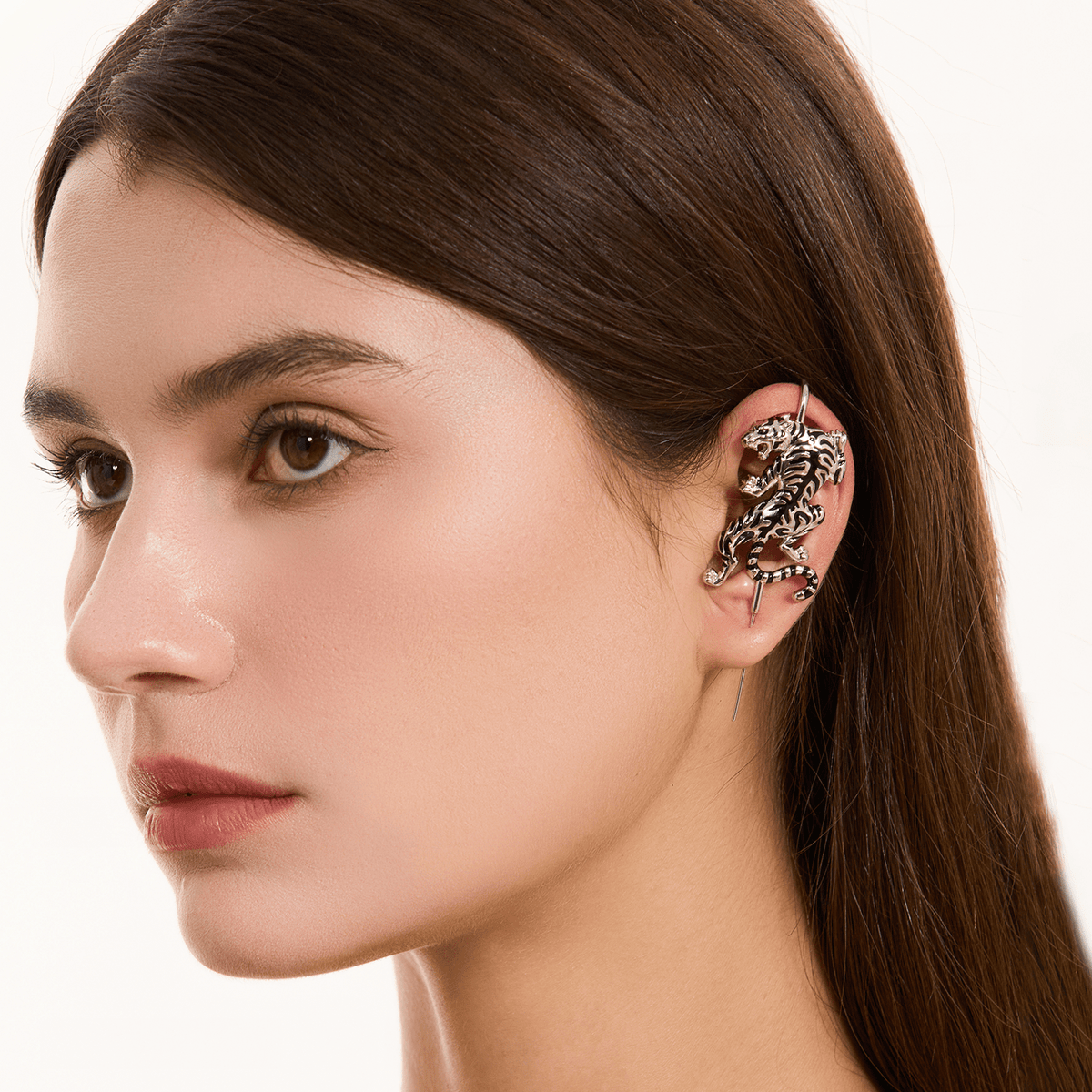 Prowling Tiger ear cuff in silver worn on the ear, profile view