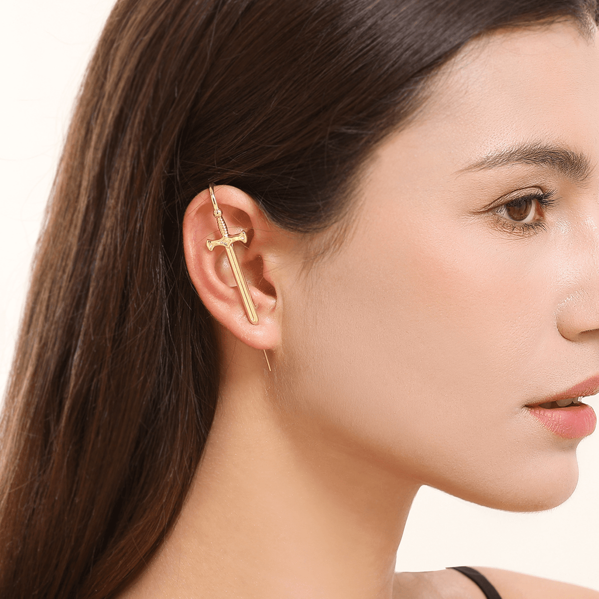 Titan's Edge ear cuff in gold worn on the ear, profile view
