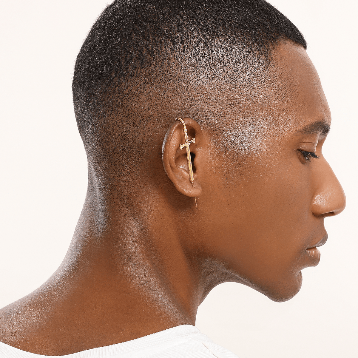Titan's Edge ear cuff in gold worn on the ear, profile view