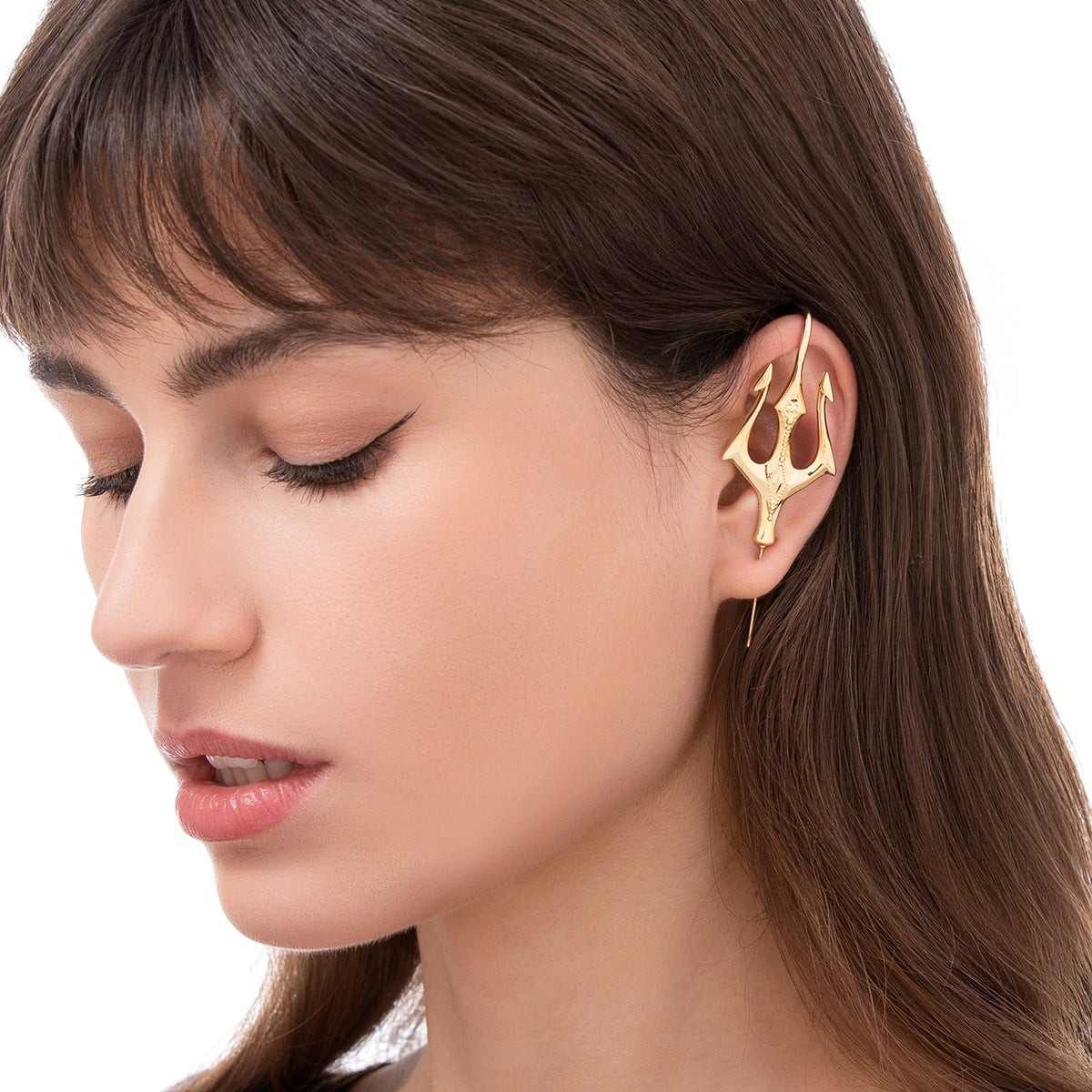 Poseidon's Trident ear cuff worn on the ear, profile view