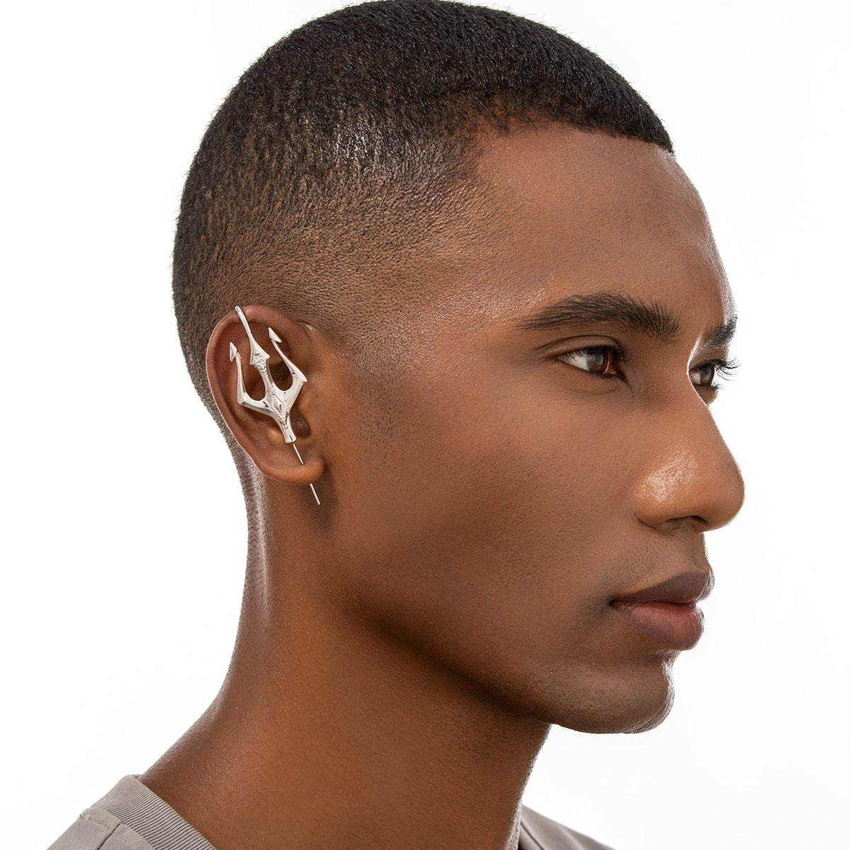 Poseidon's Trident ear cuff worn on the ear, profile view