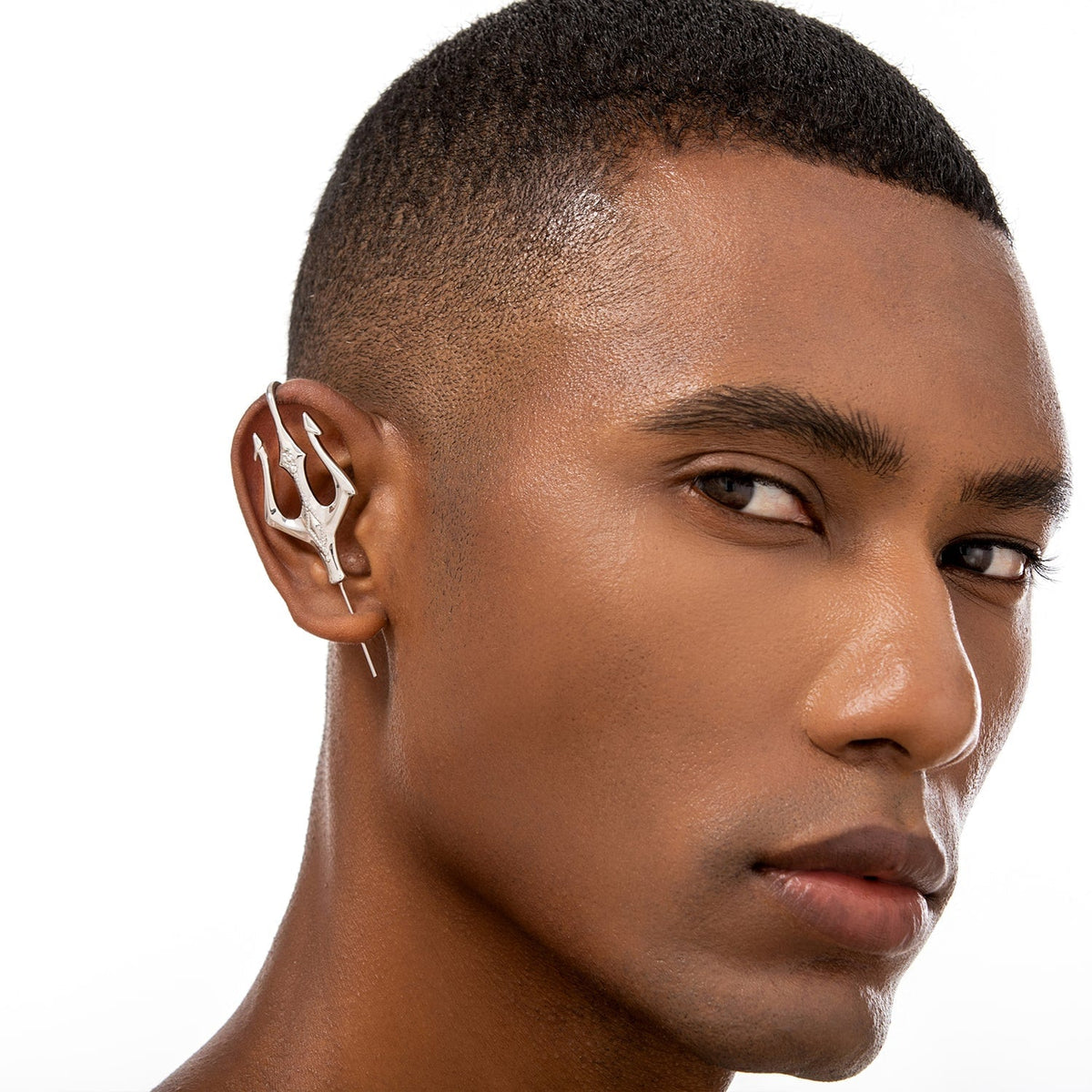 Poseidon's Trident ear cuff worn on the ear, profile view