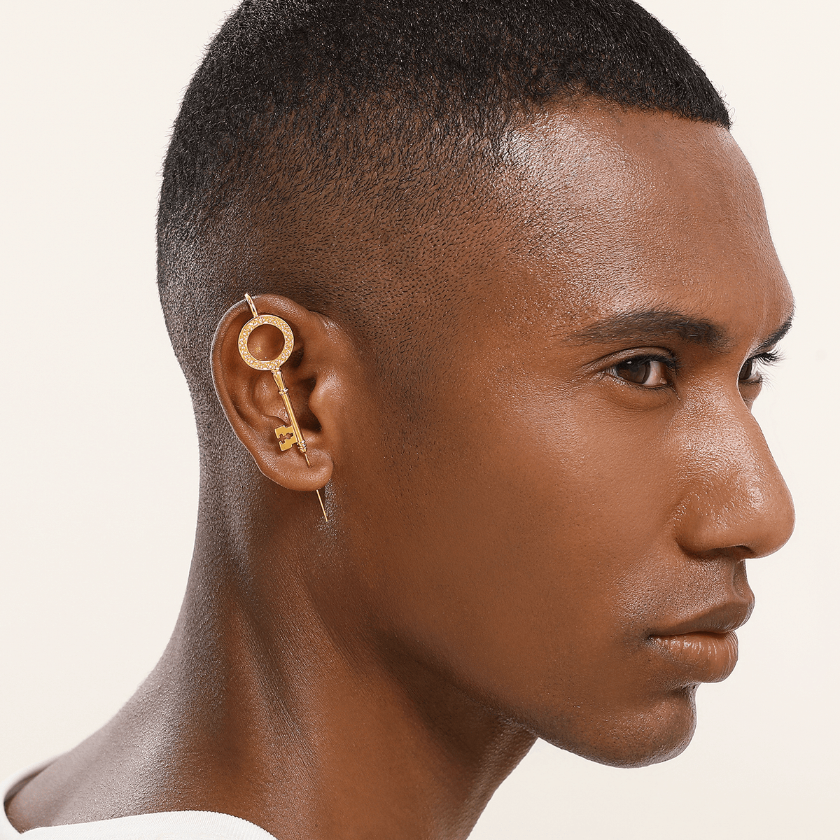 Unlocked Potential ear cuff in gold worn on the ear, profile view