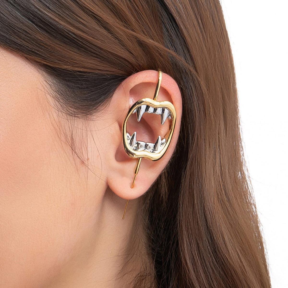 Vampire Fangs ear cuff in gold on a black ear form